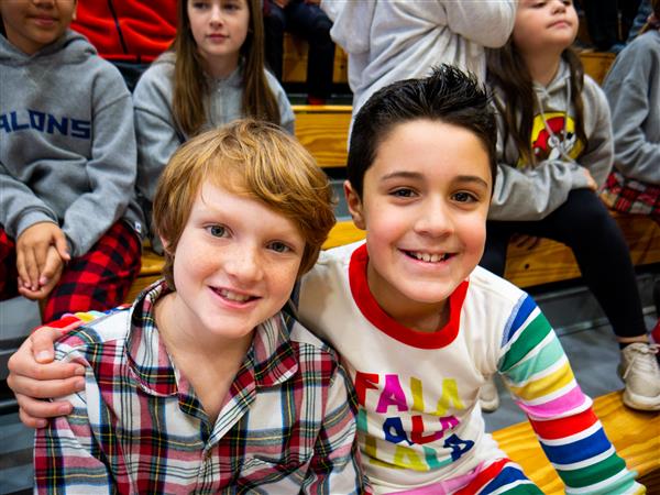 Students in holiday clothes doing festive things at school. 